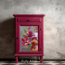 Whimsykel Fully Alive decoupage paper on a cabinet door mockup with a rich magenta painted finish and vintage-style hardware