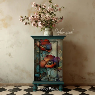 Whimsykel “Moody Petals” tissue decoupage paper applied to a teal cabinet door, featuring moody poppy blooms with teal foliage and vintage crackle texture.