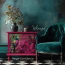 Regal Confidence peacock decoupage paper furniture makeover on a bright pink dresser in a teal room beside a velvet green chair