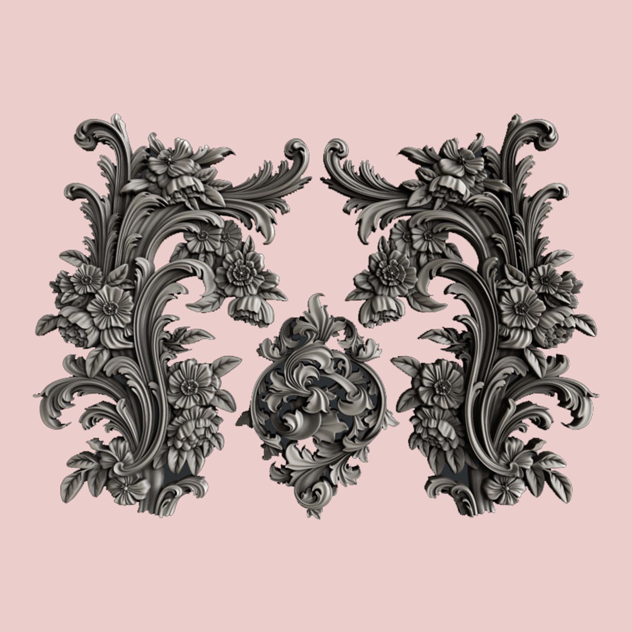 Silver colored silicone castings of 3 ornate scroll floral accent pieces are against a light pink background.