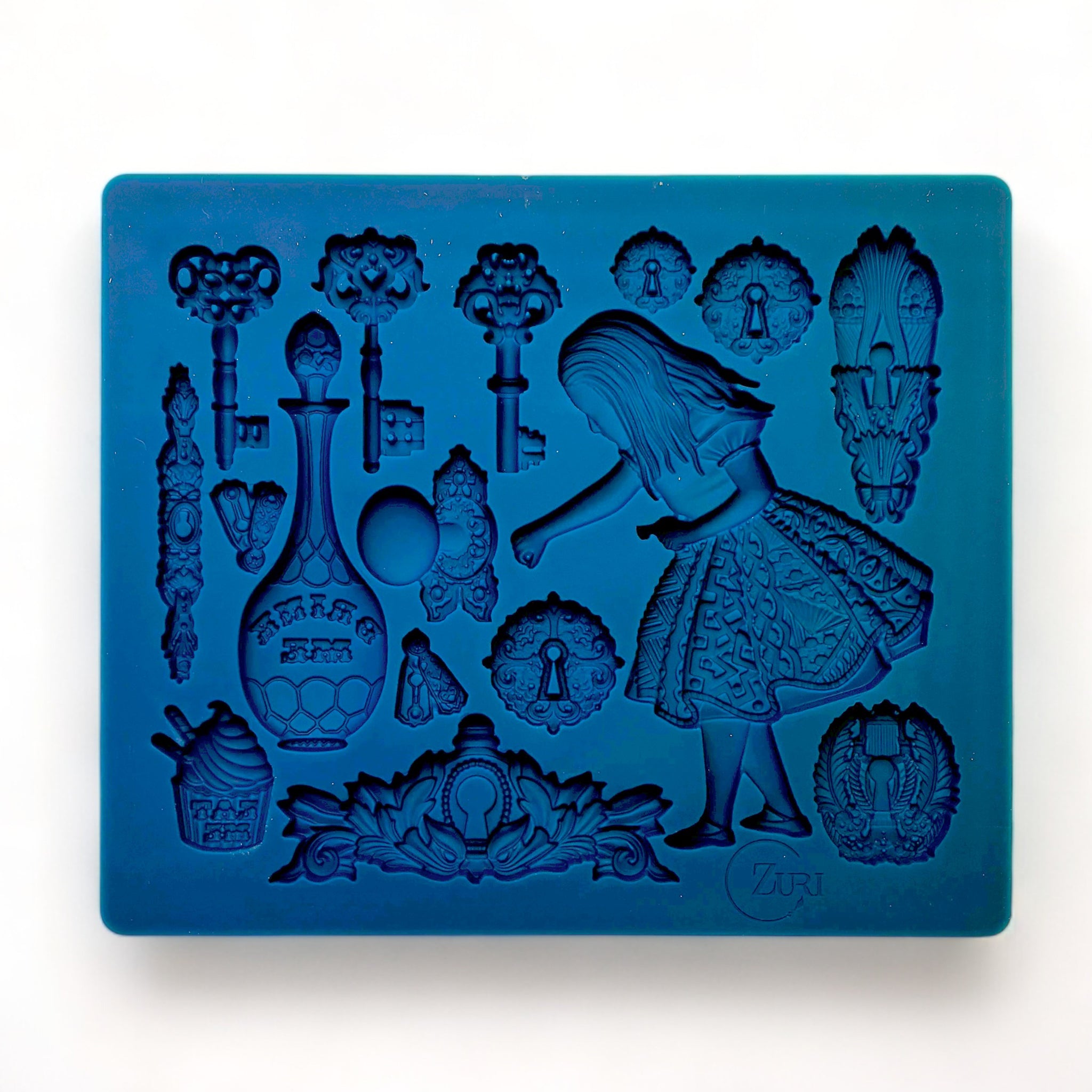 A blue silicone mold featuring Alice surrounded by keys, bottles, and other iconic images from Wonderland is against a white background.