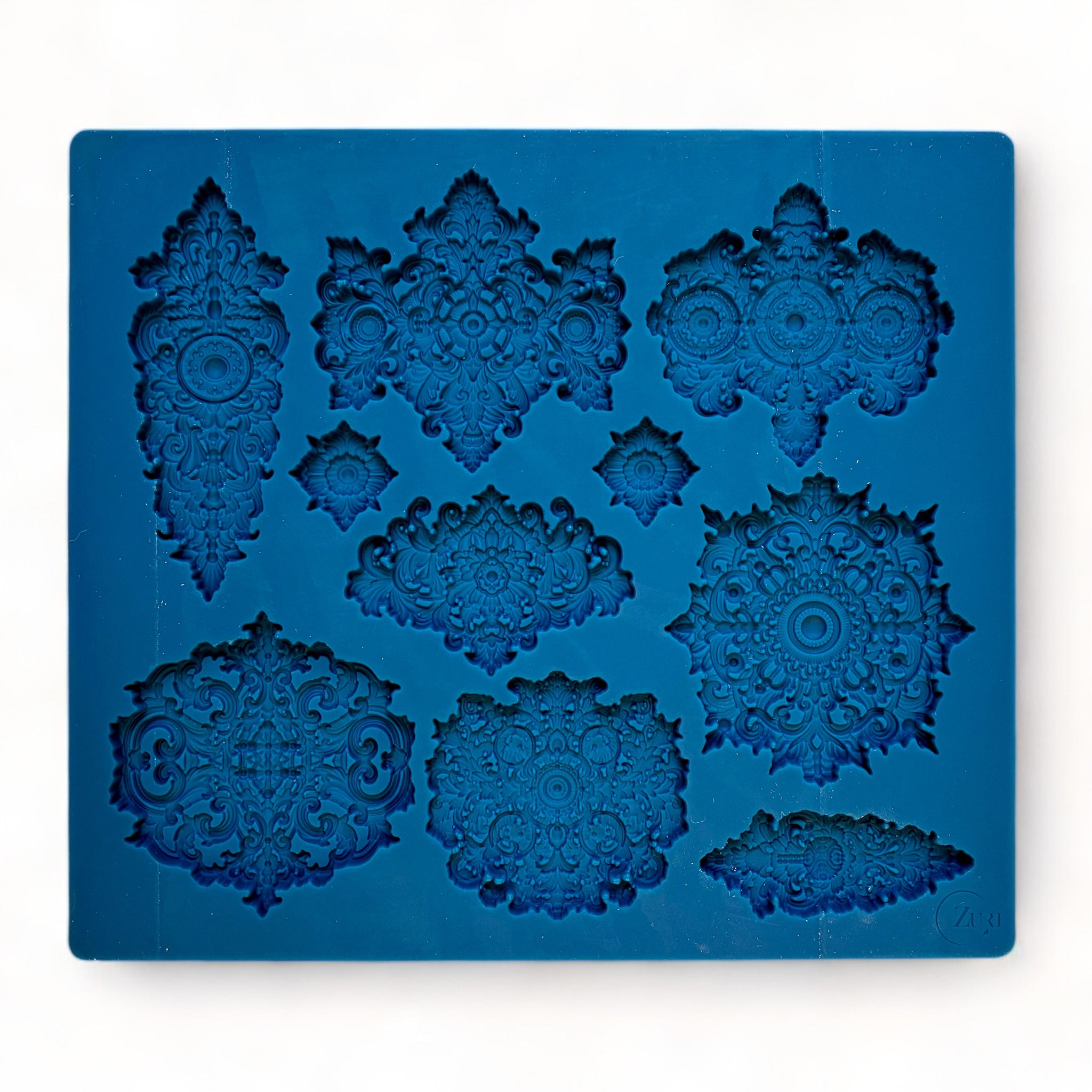 A blue silicone mold featuring 10 varying size Baroque style medallion accents is against a white background.