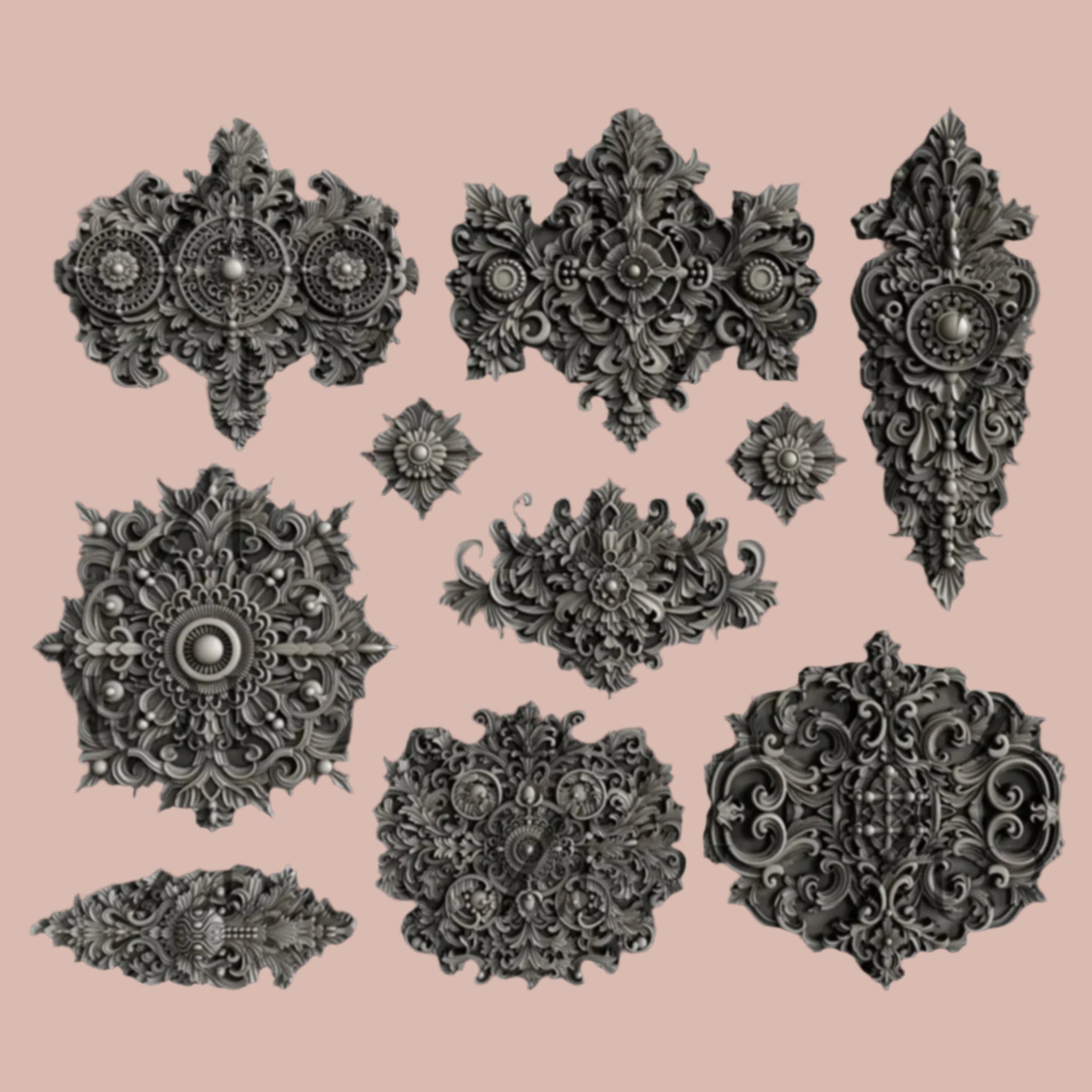 Dark silver colored silicone mold castings of 10 varying size Baroque style medallion accents are against a light pink background.