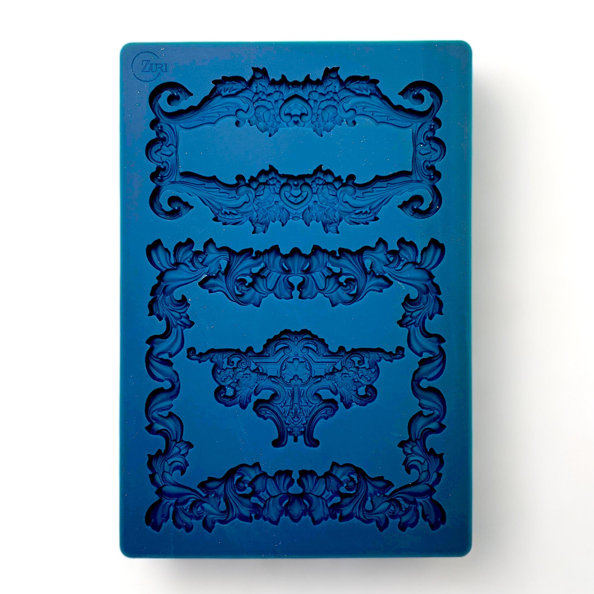 A blue silicone mold featuring 2 ornate frames and a center accent piece are against a white background.