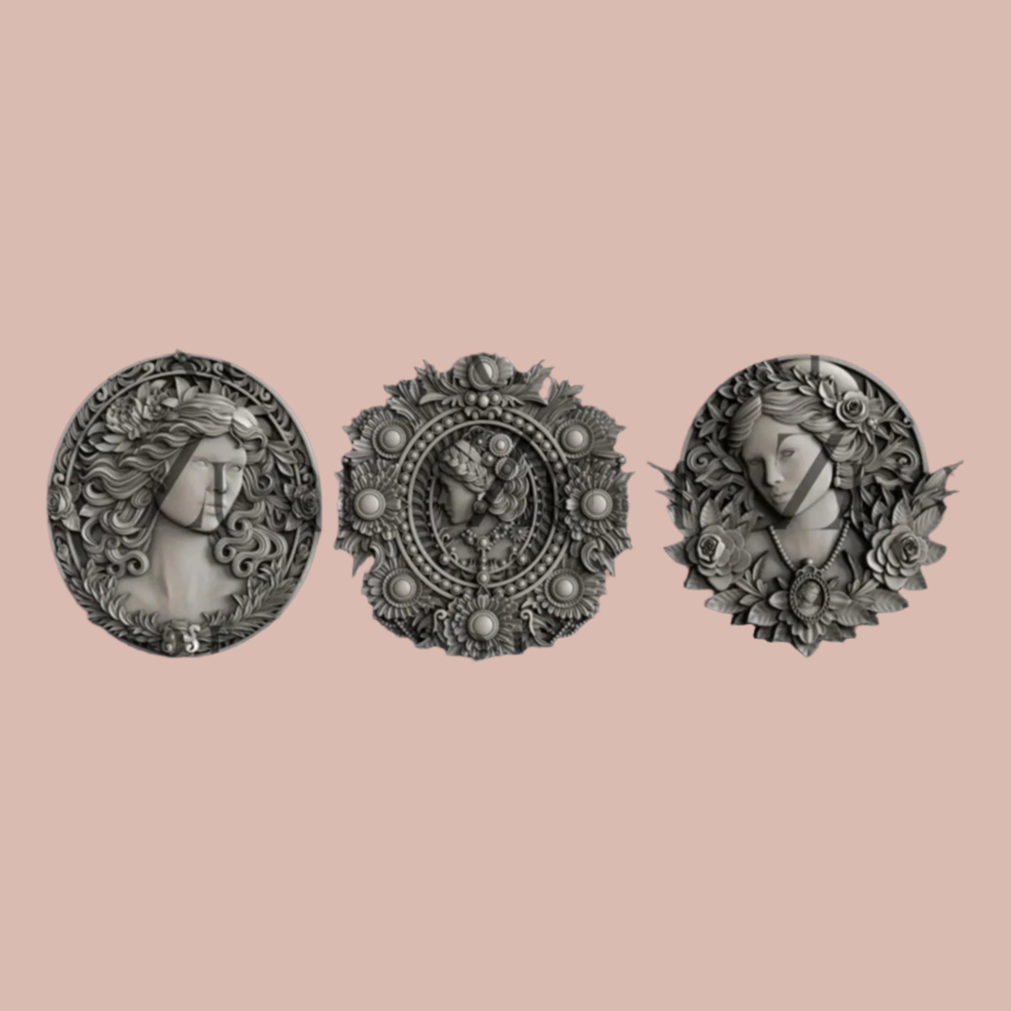 Dark silver color silicone mold castings of 3 ornate cameo medallions are against a light pink background.