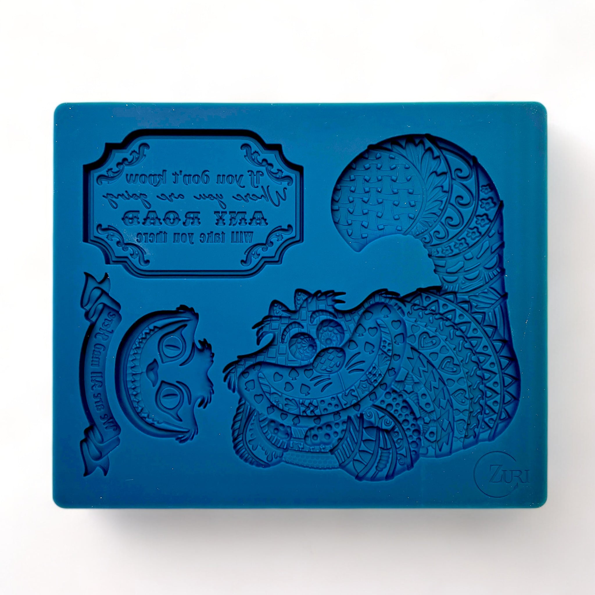 A blue silicone mold of Zuri Design's Cheshire Cat is against a white background.