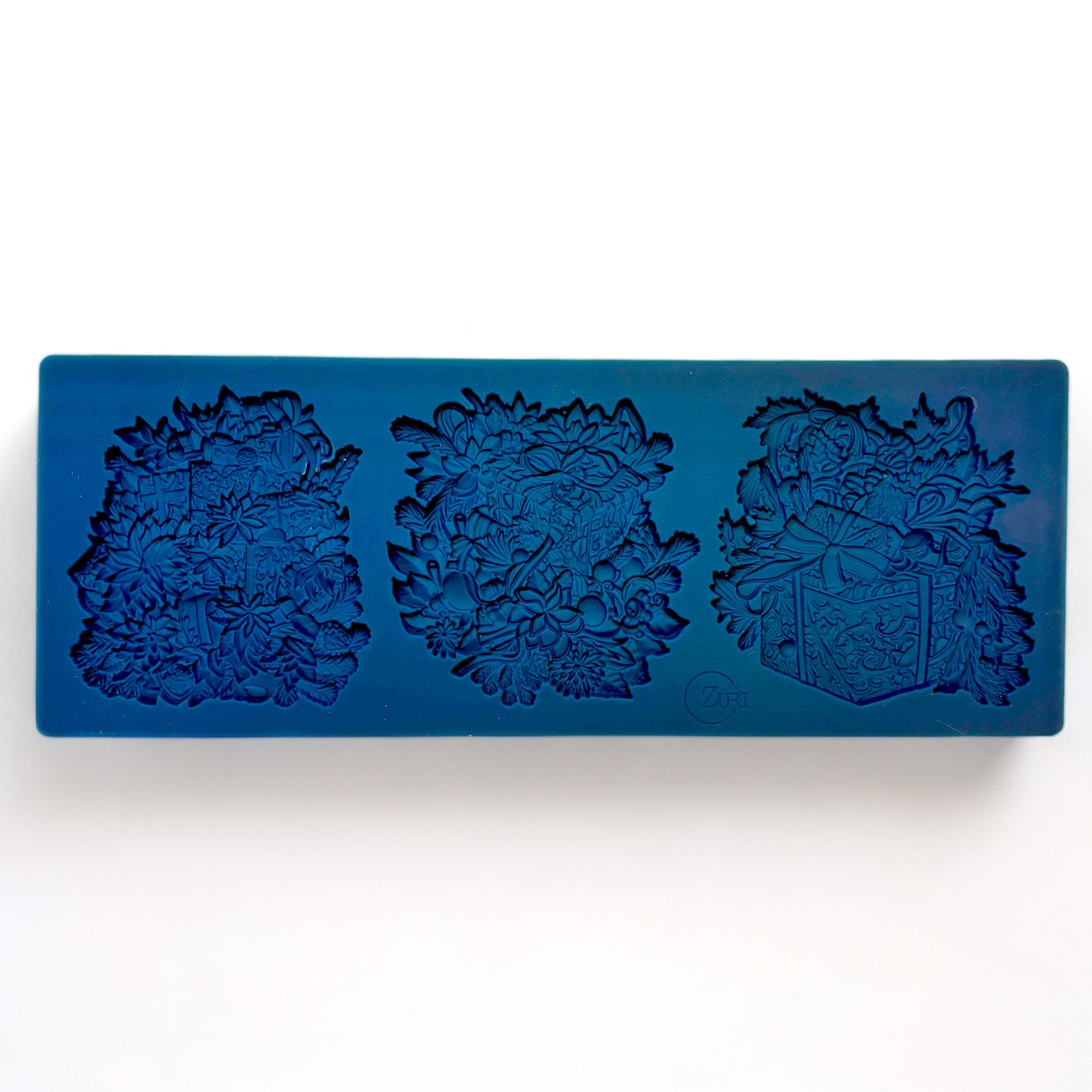 A blue silicone mold of Zuri Design's Christmas Gifts Set 2 is against a white background.