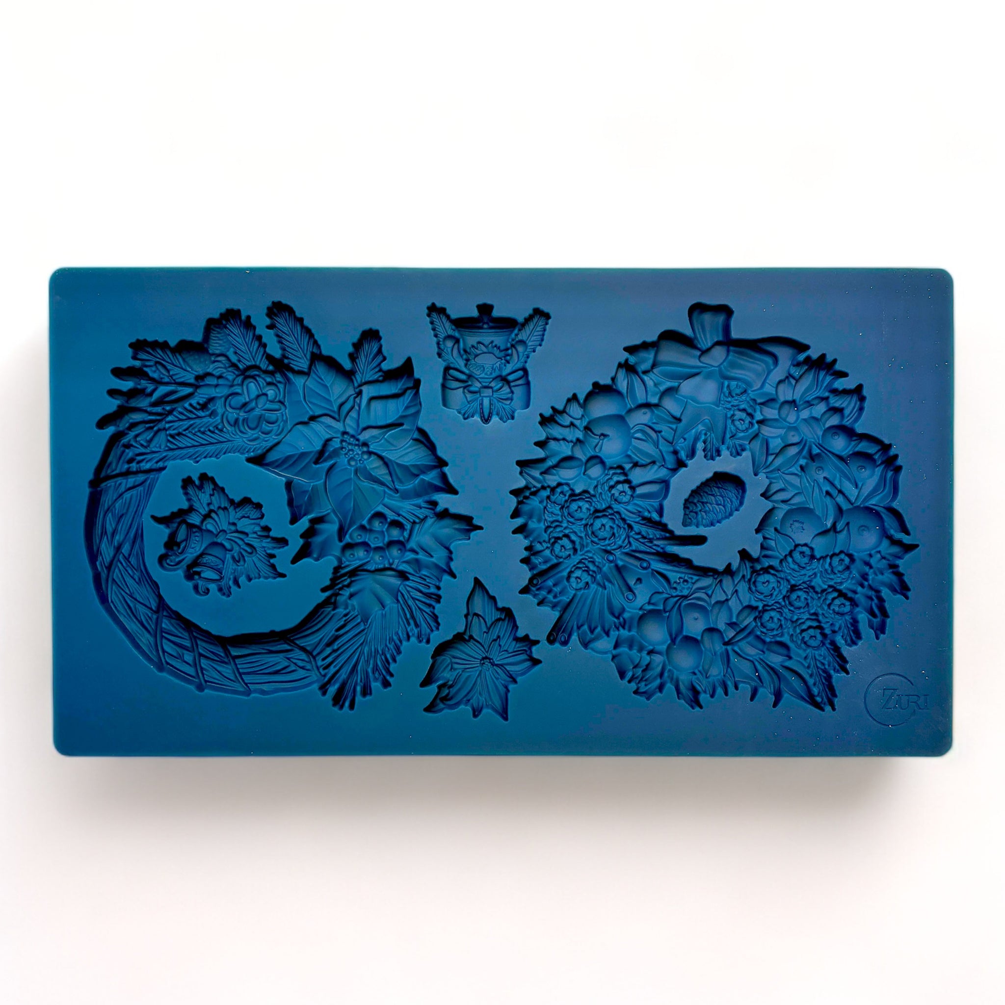 A blue silicone mold of Zuri Design's Christmas Wreaths is against a white background.