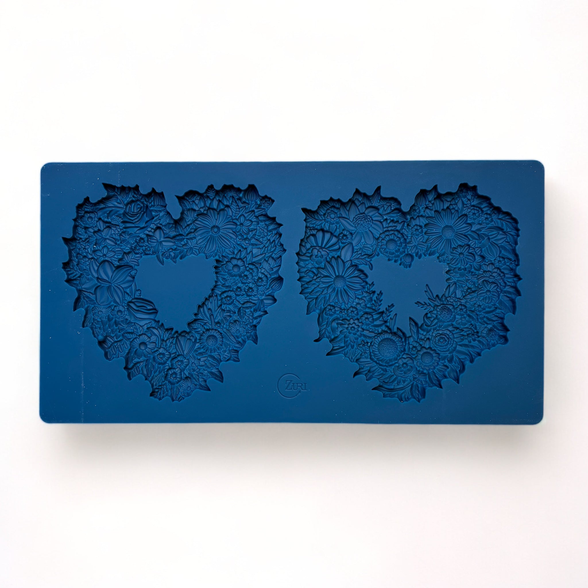 A blue silicone mold of 2 floral heart frames is against a white background.