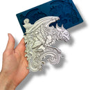 Zuri's Gargoyles Set 1 silicone mold is against a white background with a hand holding one of its large gargoyle castings.