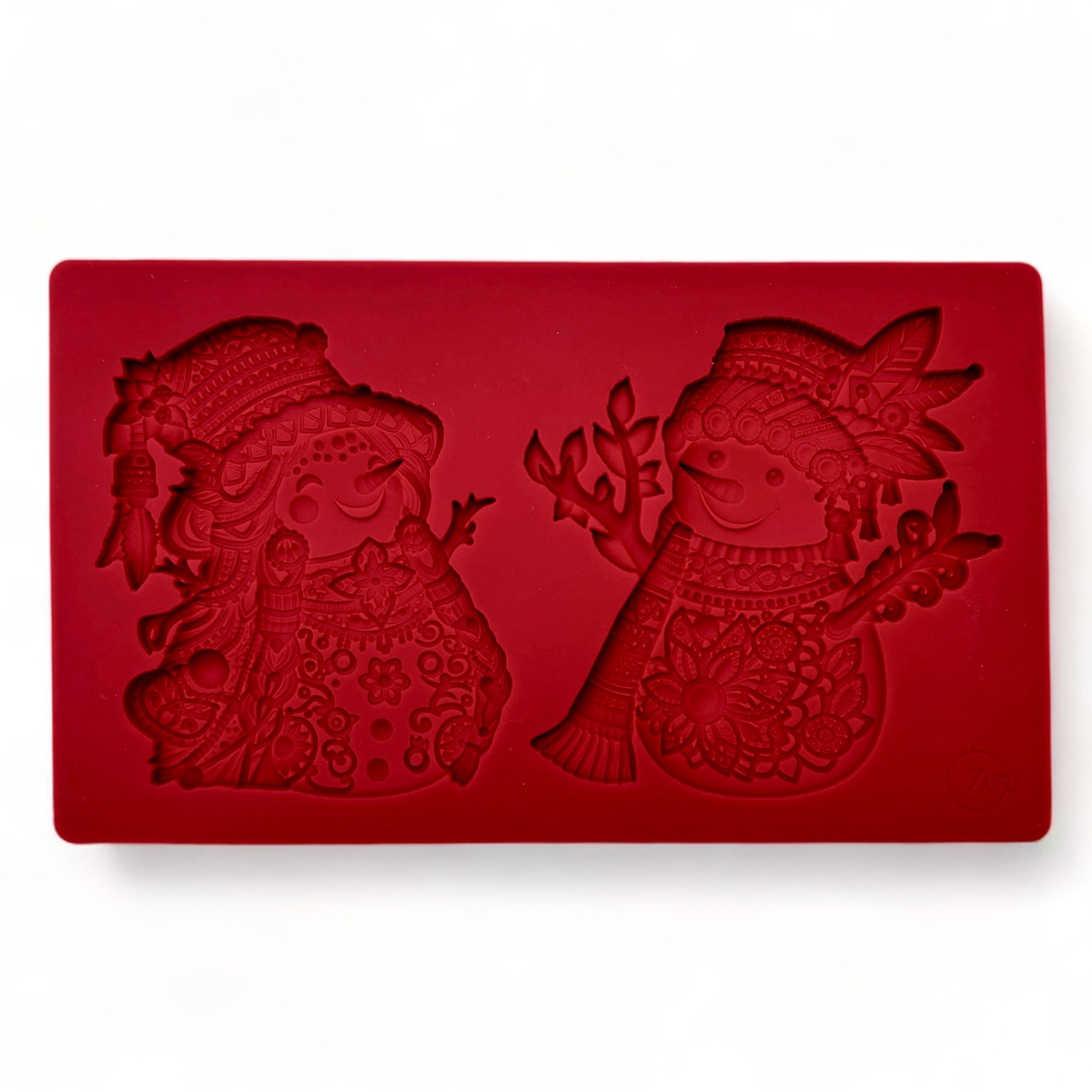 A red silicone mold featuring 2 ornately decorated Bohemian style snowmen are against a white background.