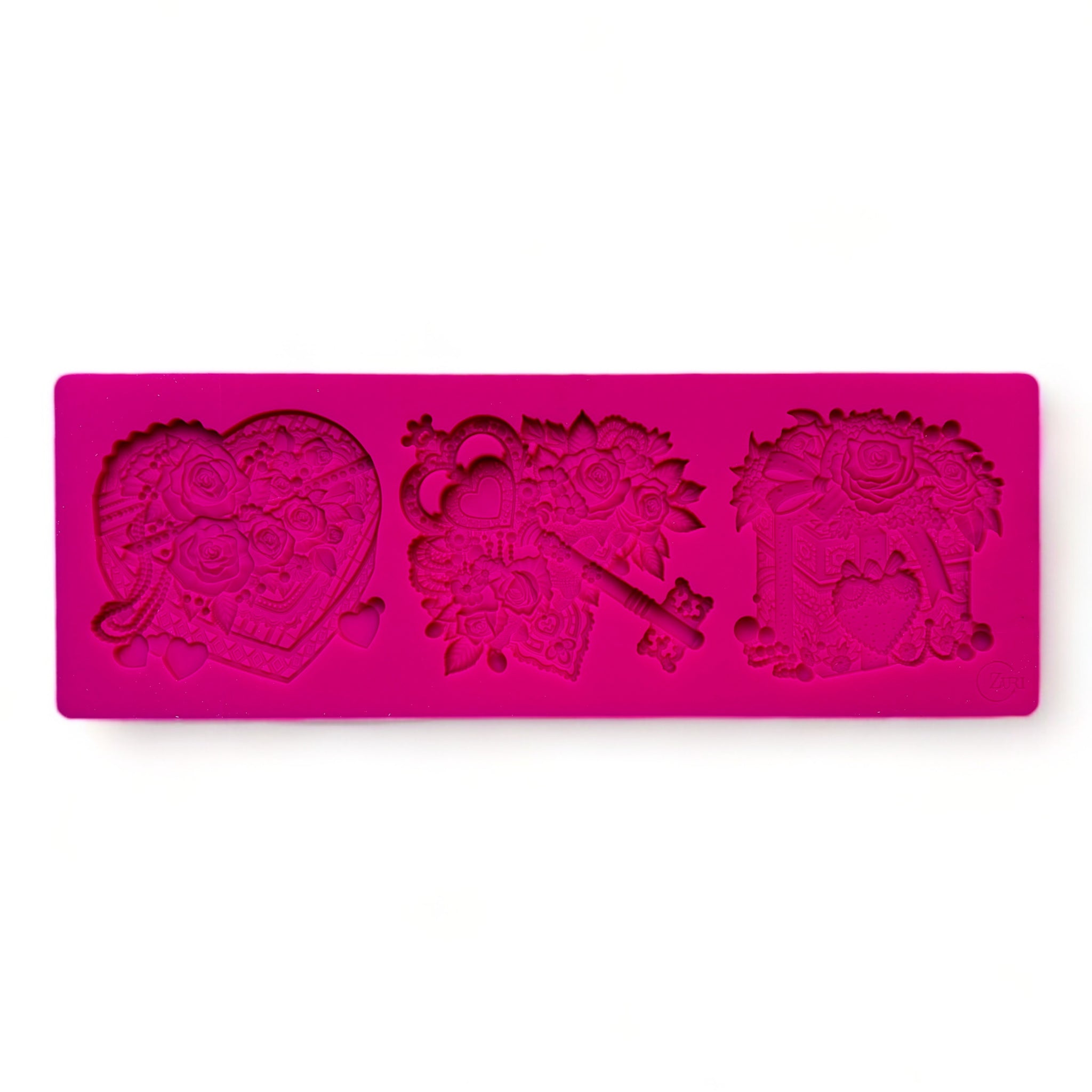 A pink silicone mold of a Valentine's Day gift box, box of chocolates, and a key surrounded by flowers is against a white background.