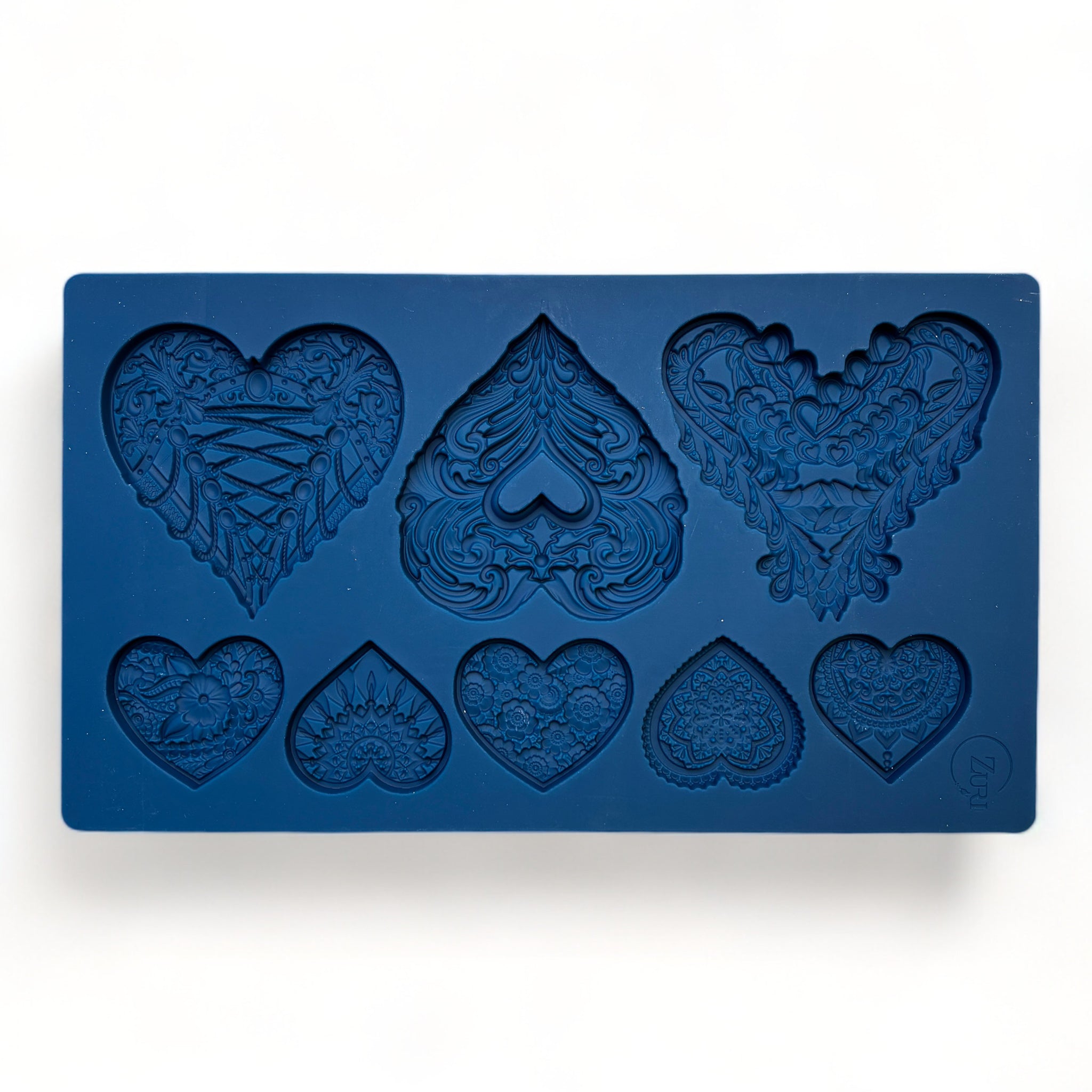 A blue silicone mold of 3 large and 5 small ornately decorated hearts is against a white background.