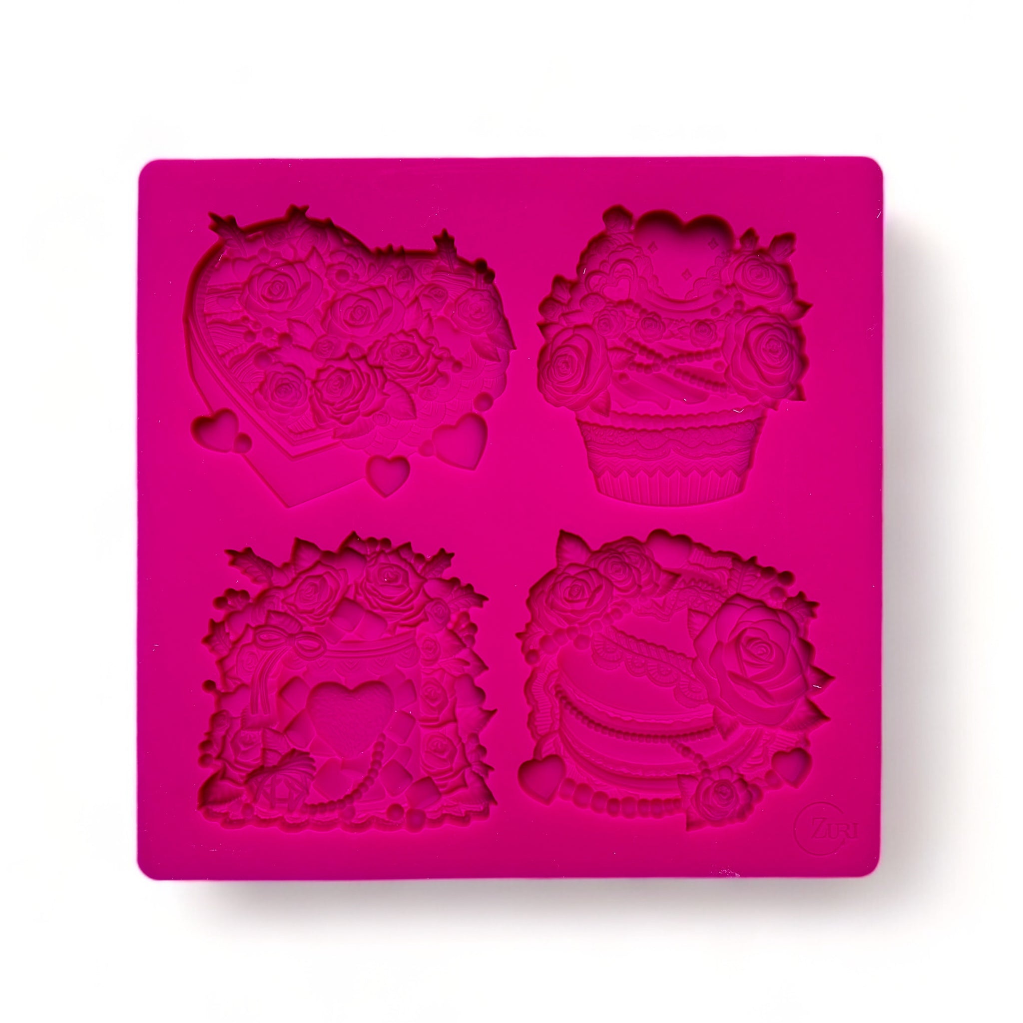 A pink silicone mold of 4 Valentine's Day candy boxes surrounded with flowers is against a white background.