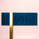 A blue silicone mold of 3 tiles featuring butterflies, flowers and calligraphy is against a light pink background. A gold ruler reading 4.8" height sits on the mold.