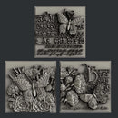 Silver colored castings of 3 tiles featuring butterflies, flowers and calligraphy are against a dark grey background.