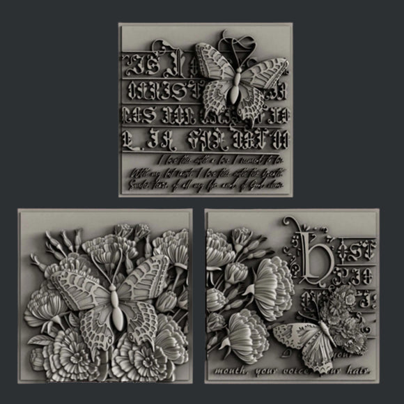 Silver colored castings of 3 tiles featuring butterflies, flowers and calligraphy are against a dark grey background.