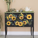 Sunflower Fields furniture decal by Redesign placed on a black buffet table. The design consists of 12 sunflower heads, extra greens and delicate blue blossoms.
