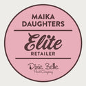 A white background with a pink circle with a brown outline and brown text reading: Maika Daughters. Elite retailer. Dixie Belle paint company.