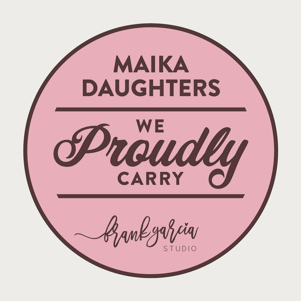 A white background with a pink circle, brown outline, and brown text that reads: Maika Daughters. We proudly carry Frank Garcia Studios (using the Frank Garcia Studios logo).
