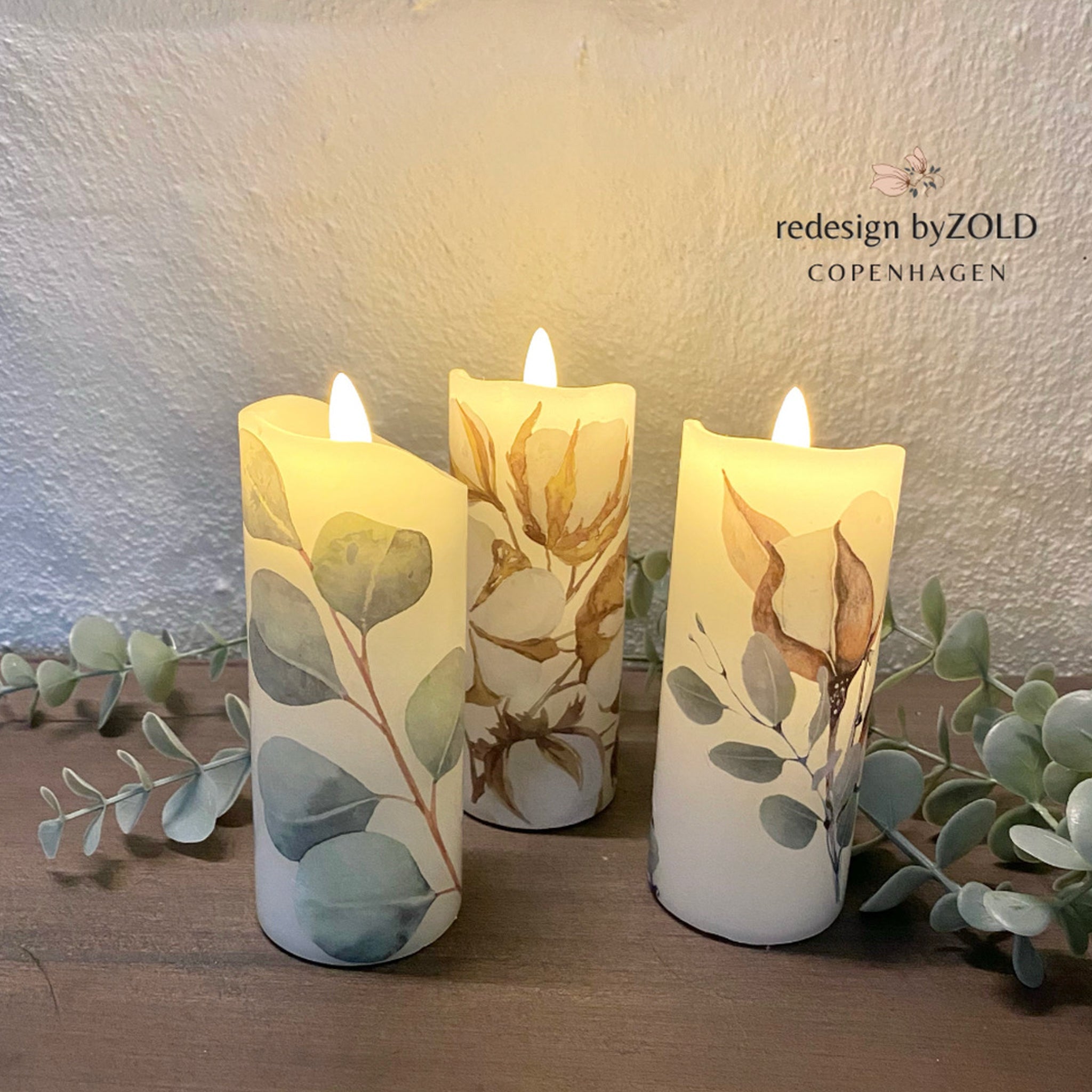 Three battery operated white candles refurbished by Redesign by Zold Copenhagen feature the Cotton and Eucalyptus furniture transfer.
