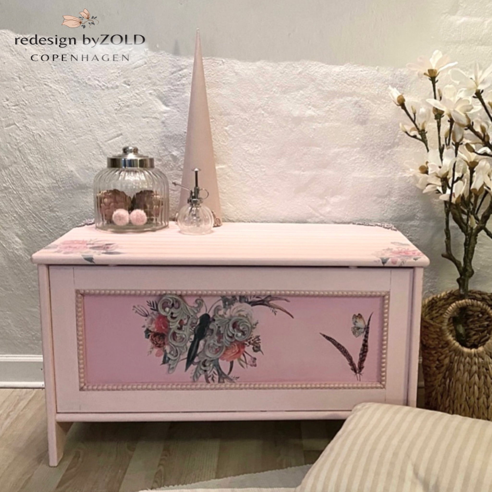 A vintage storage chest refurbished by Redesign by Zold Copenhagen is painted in pale pinks and feature the Flower Child transfer.