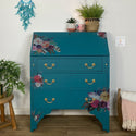 A vintage secretary desk refurbished by Cherub's Chalk Interiors is painted teal blue and features the Flower Child Transfer on it.