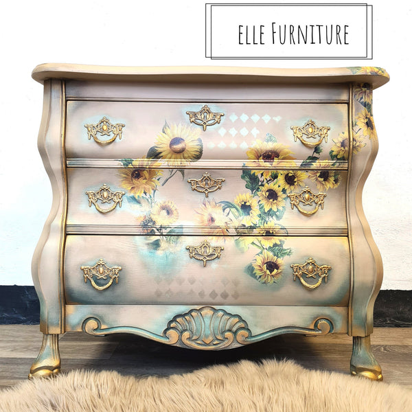 A vintage dresser refurbished by Elle Furniture is painted a light beige and features the Sunflowers Transfer on the front of it.