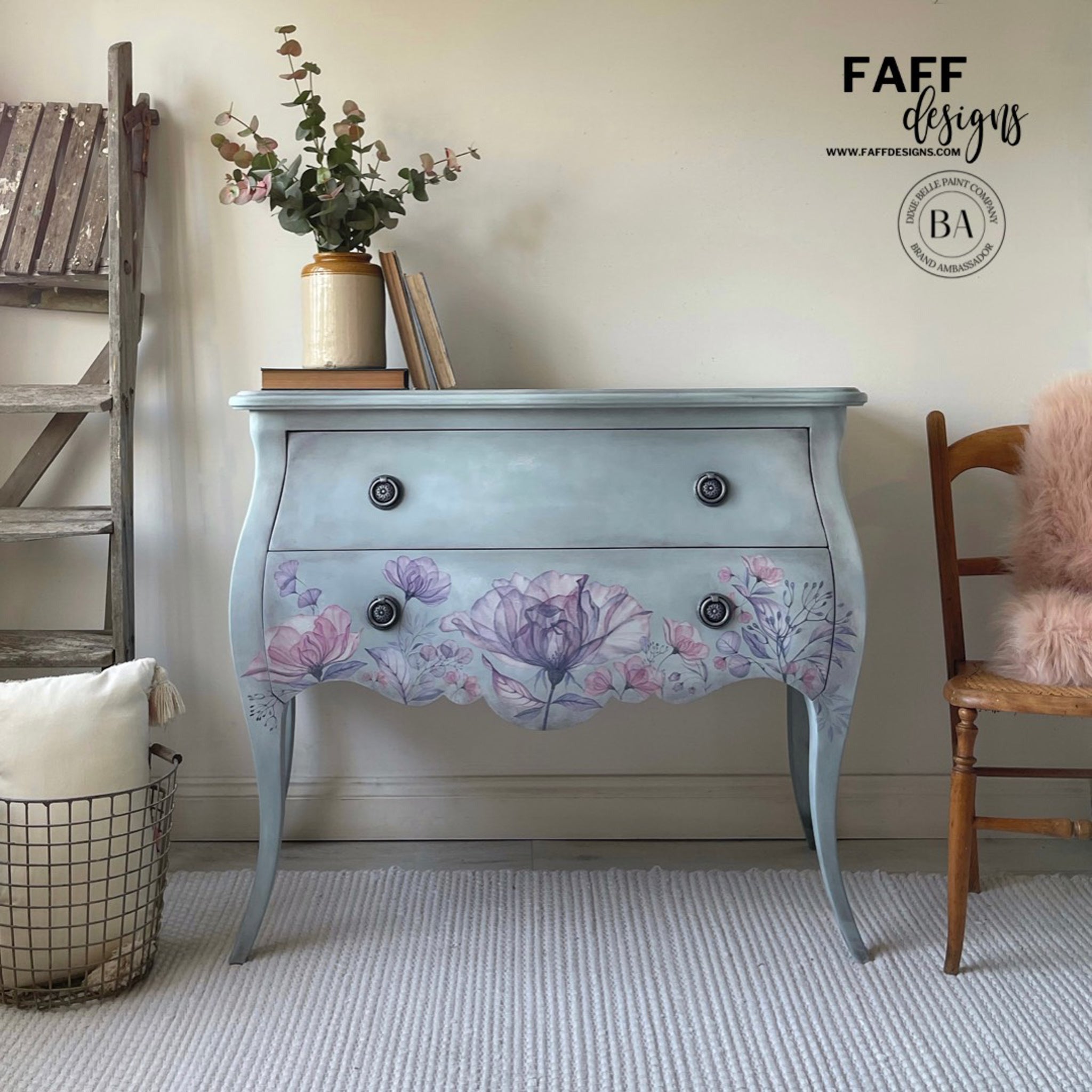A vintage 2-drawer nightstand refurbished by Faff Designs, a Dixie Belle Paint Company Brand Ambassador, is painted light blue and features the Translucent Garden Transfer on the front bottom.