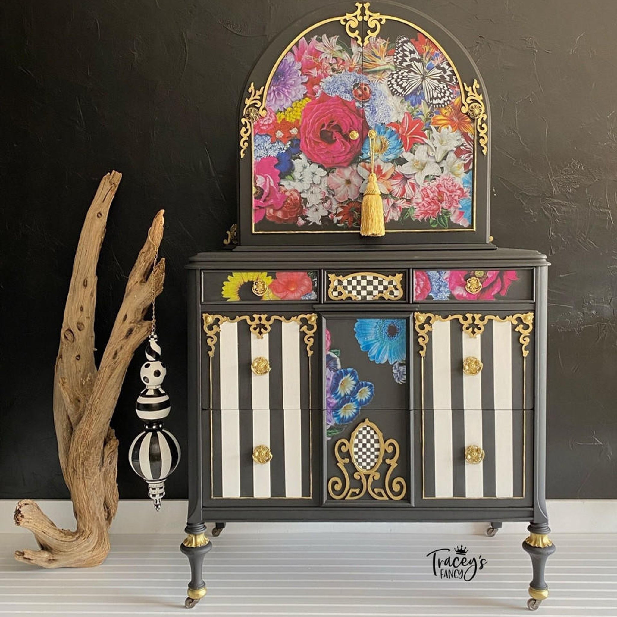 A vintage vanity dresser refurbished by Tracey's Fancy is painted black with white stripes on the drawers and features the Whimsical Wonderland Transfer on it.