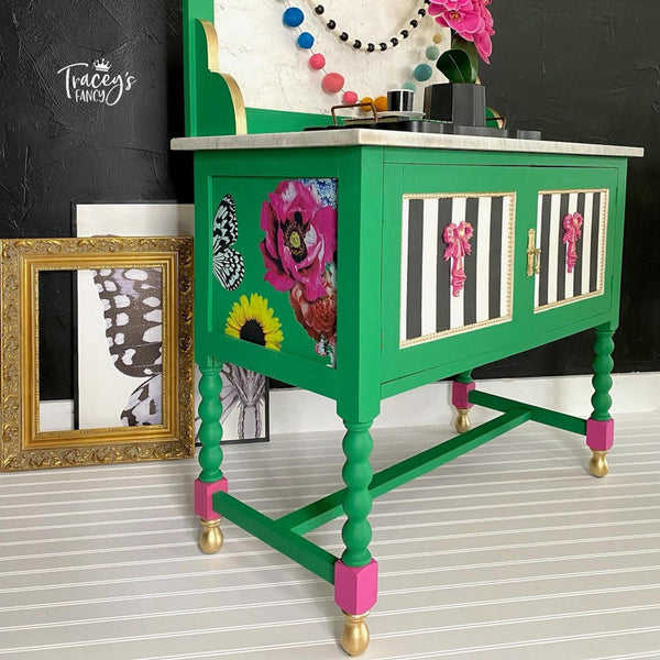 A vintage side table with cabinet doors refurbished by Tracey's Francy i painted bright green and features black & white stripes on the front and the Whimsical Wonderland Transfer on the sides.