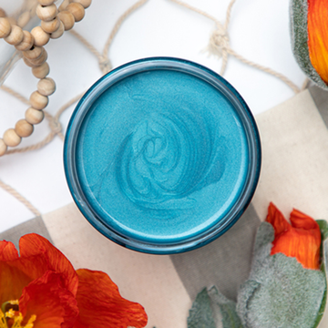 A open Caribbean Dixie Belle Moonshine Metallic Chalk Paint container.