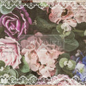 This decoupage paper by ReDesign with Prima has large pastel colored roses and flowers against a dark green background of large leaves. The edges of the paper is adorned with white lace. Some black handwriting throughout.