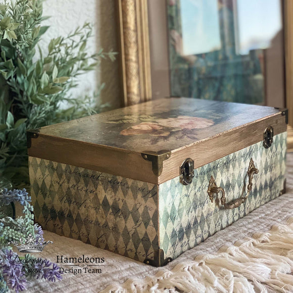 A small wood box refurbished by Hameleons Design Team is decorated with the Neutral Harlequin rice paper. A natural wood stain and Sandrina rice paper is on the lid.