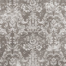 Close-up of a rice paper featuring a light colored distressed floral damask design against a grey background.