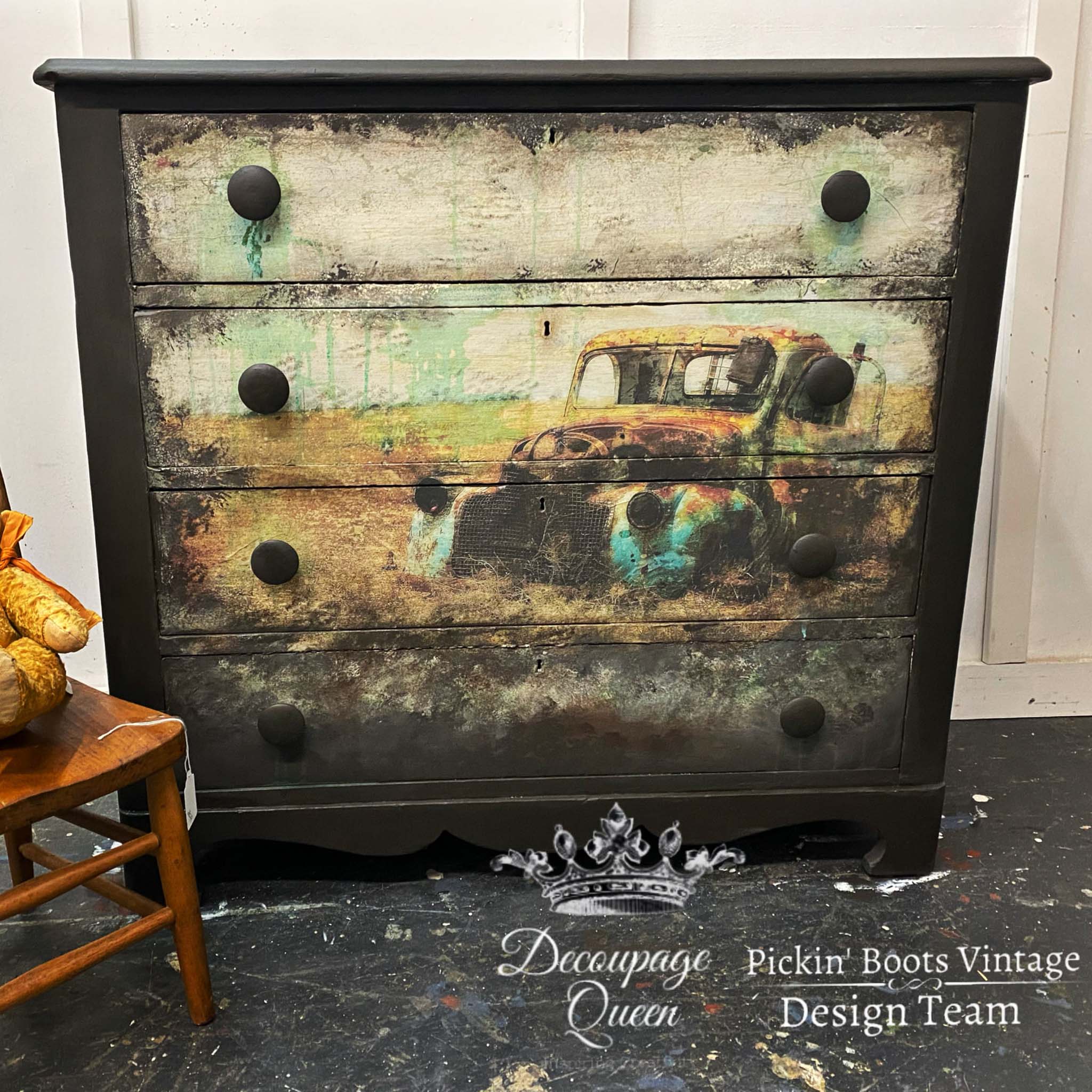 Black dresser with the Abandoned decoupage paper on top. A white Decoupage Queen and Pickin Boots Vintage Design Team logo on the bottom right.