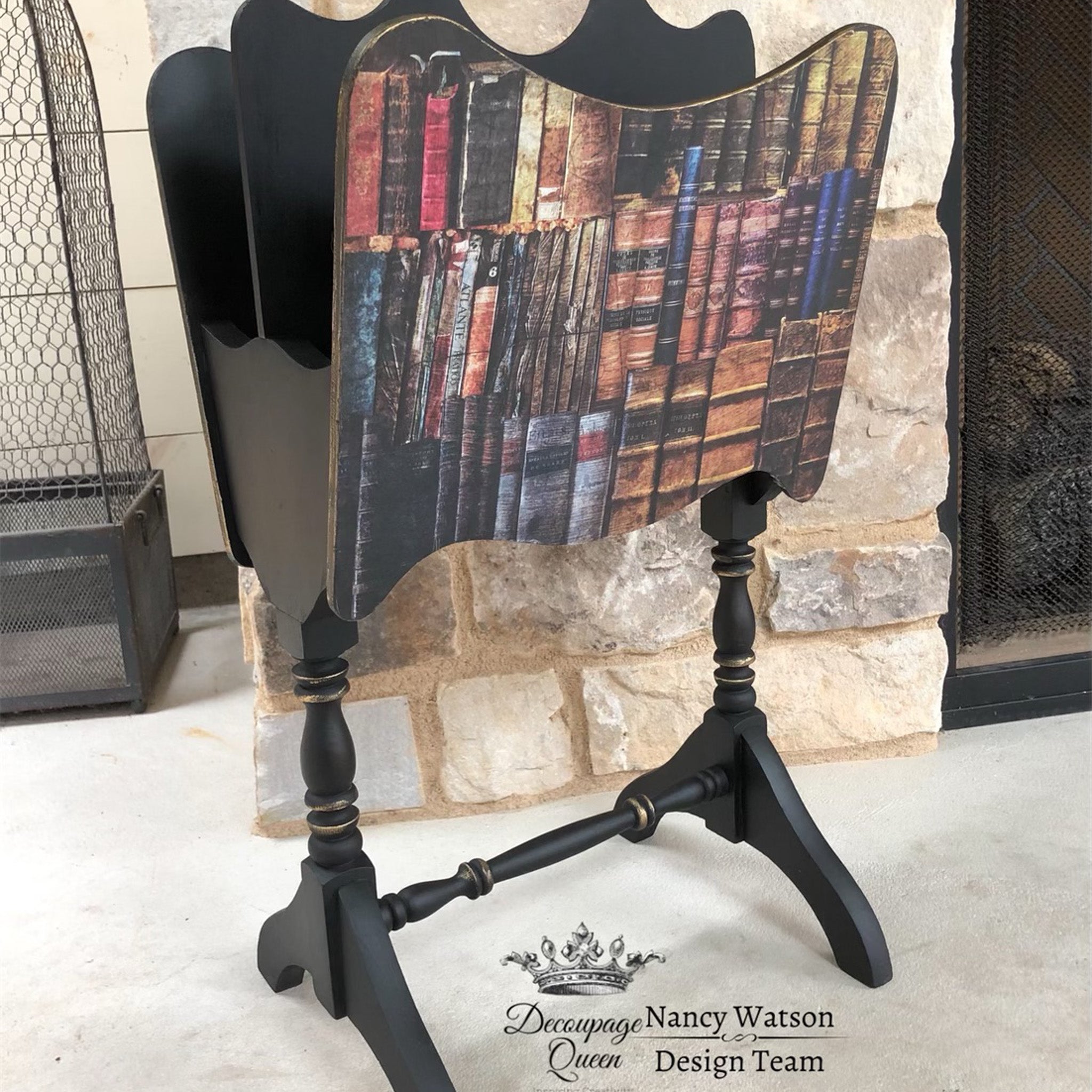 A black book organizer stand with the Dusty Library decoupage paper on top. A black Decoupage Queen and Nancy Watson Design Team logo on the bottom right.