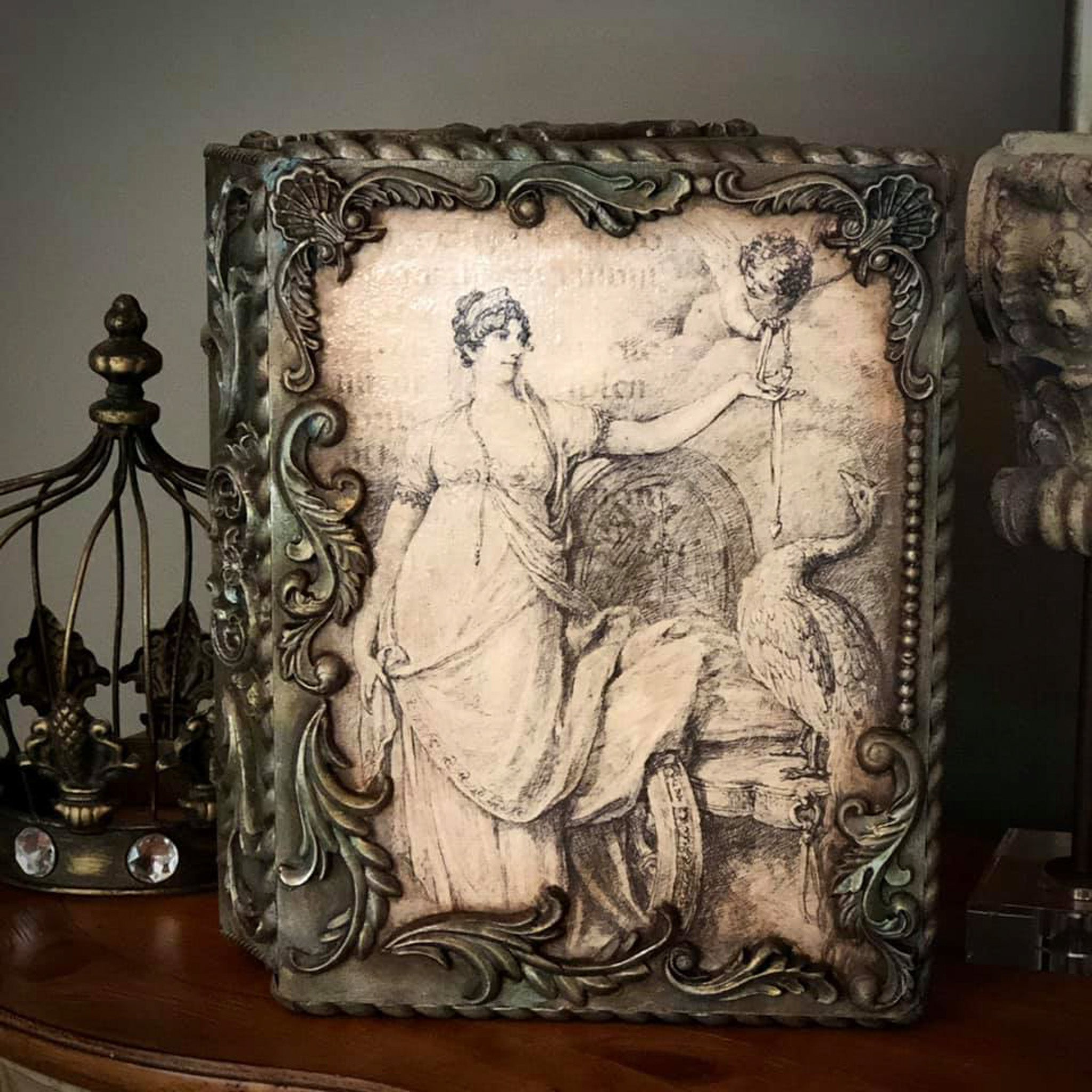 Ornate decor piece with the Juno and Cupid decoupage paper on top. 