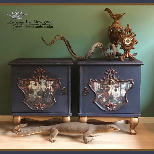 Two small dressers with the Pocket Watches decoupage paper on top. A black Decoupage Queen and Ilse Lievegoed brand ambassador logo on the top left.