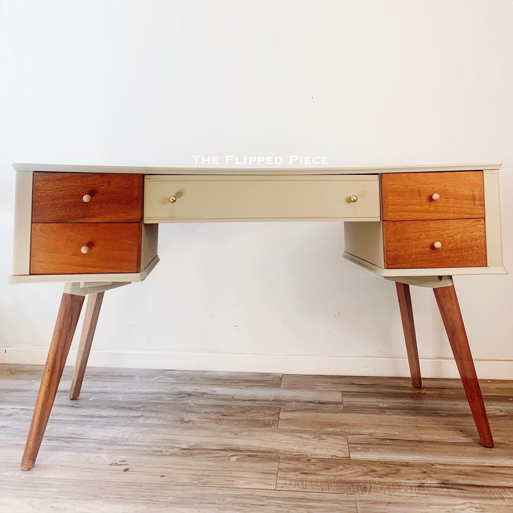 A mid-century desk refurbished by The Flipped Piece is painted partially in Dixie Belle's Dried Sage mineral chalk paint along with a natural wood finish.