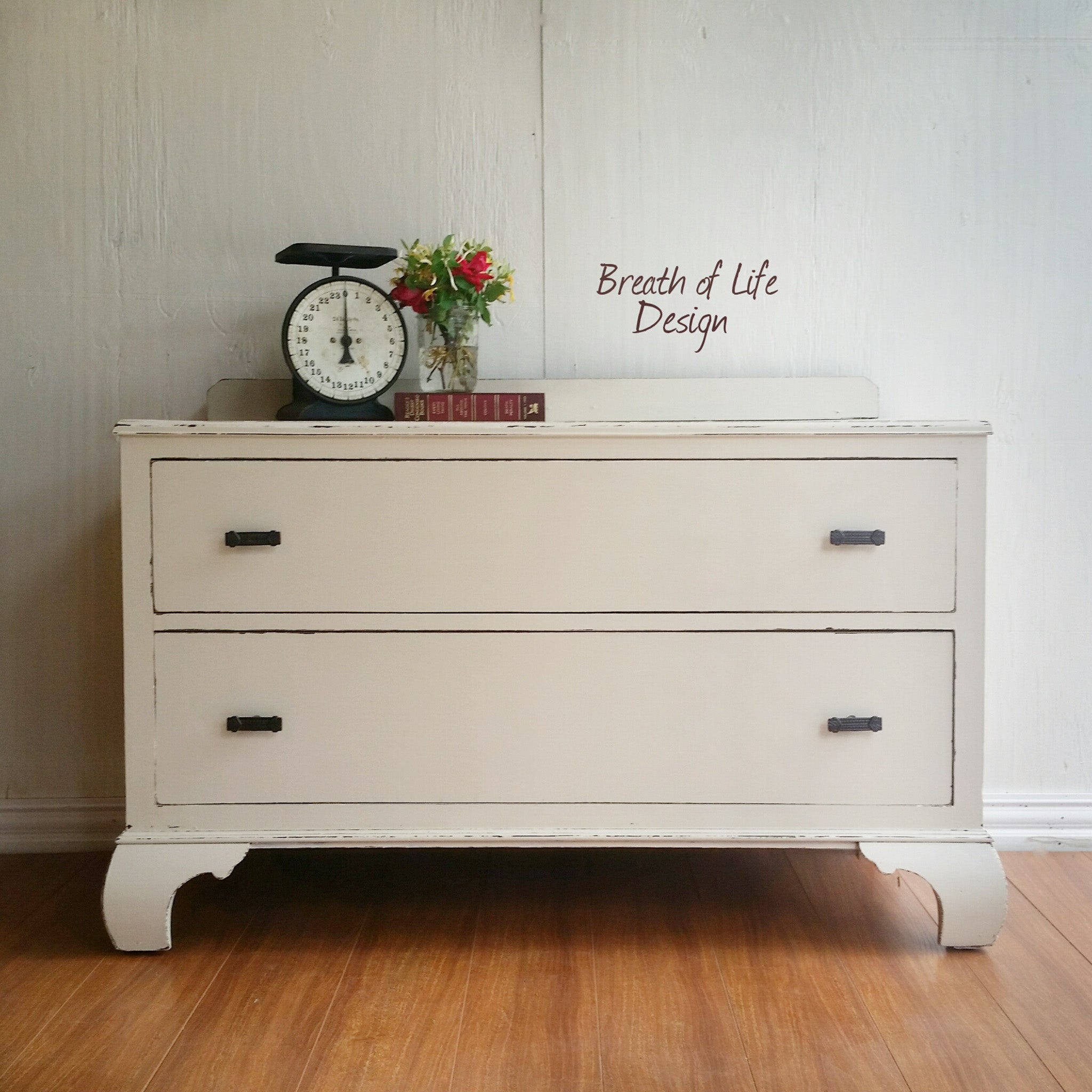 A vintage 2-drawer small dresser refurbished by Breath of Life Design is painted in Dixie Belle's Drop Cloth chalk mineral paint.