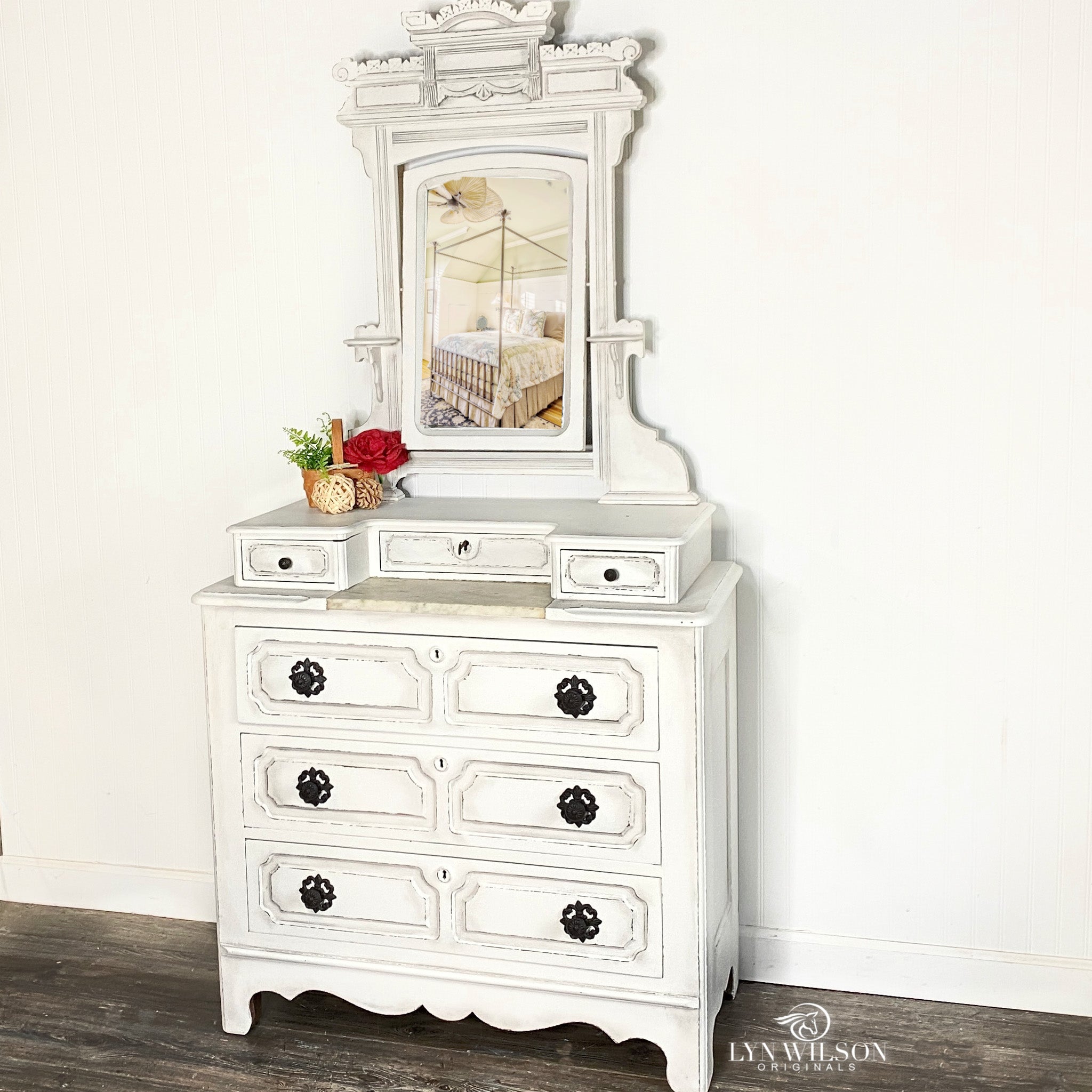 A vintage lingerie dresser with a mirror refurbished by Lyn Wilson is painted in Dixie Belle's Fluff chalk mineral paint.