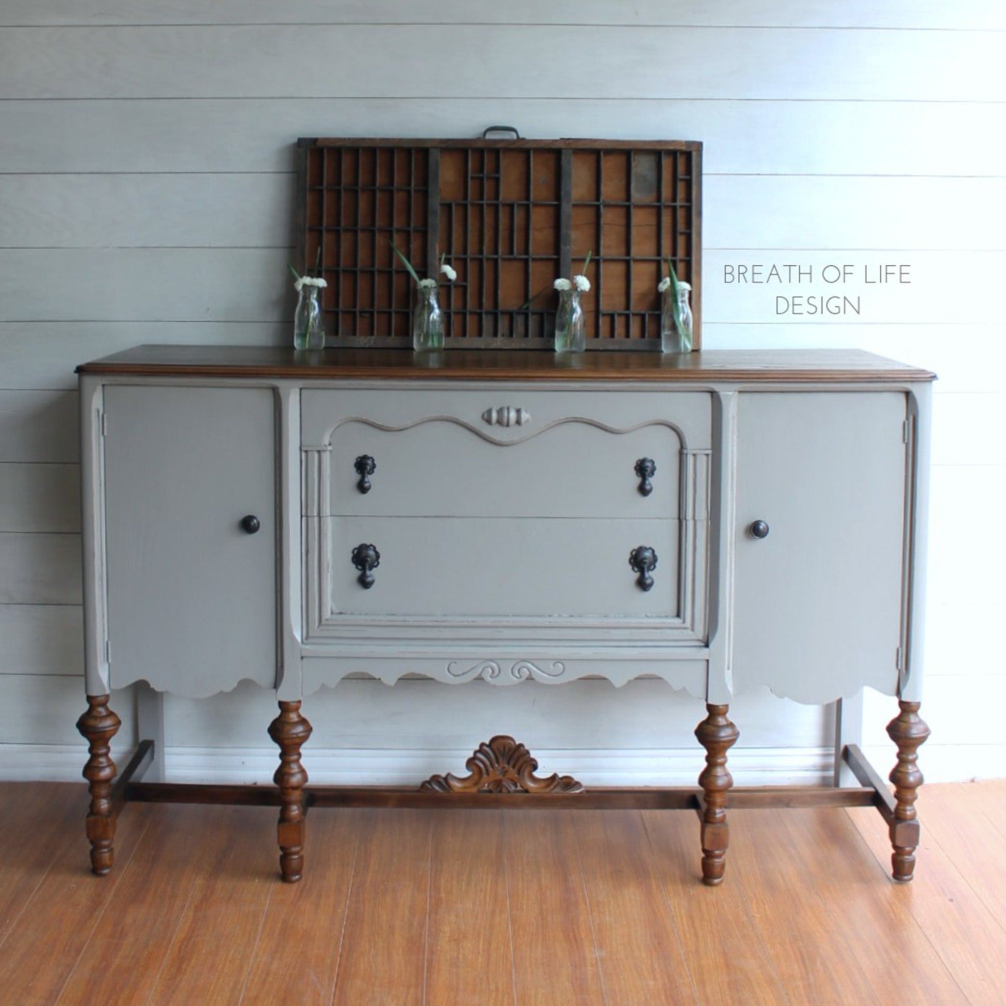 A vintage buffet console refurbished by Breath of Life Design is painted in Dixie Belle's French Linen chalk mineral paint and has natural wood accents.