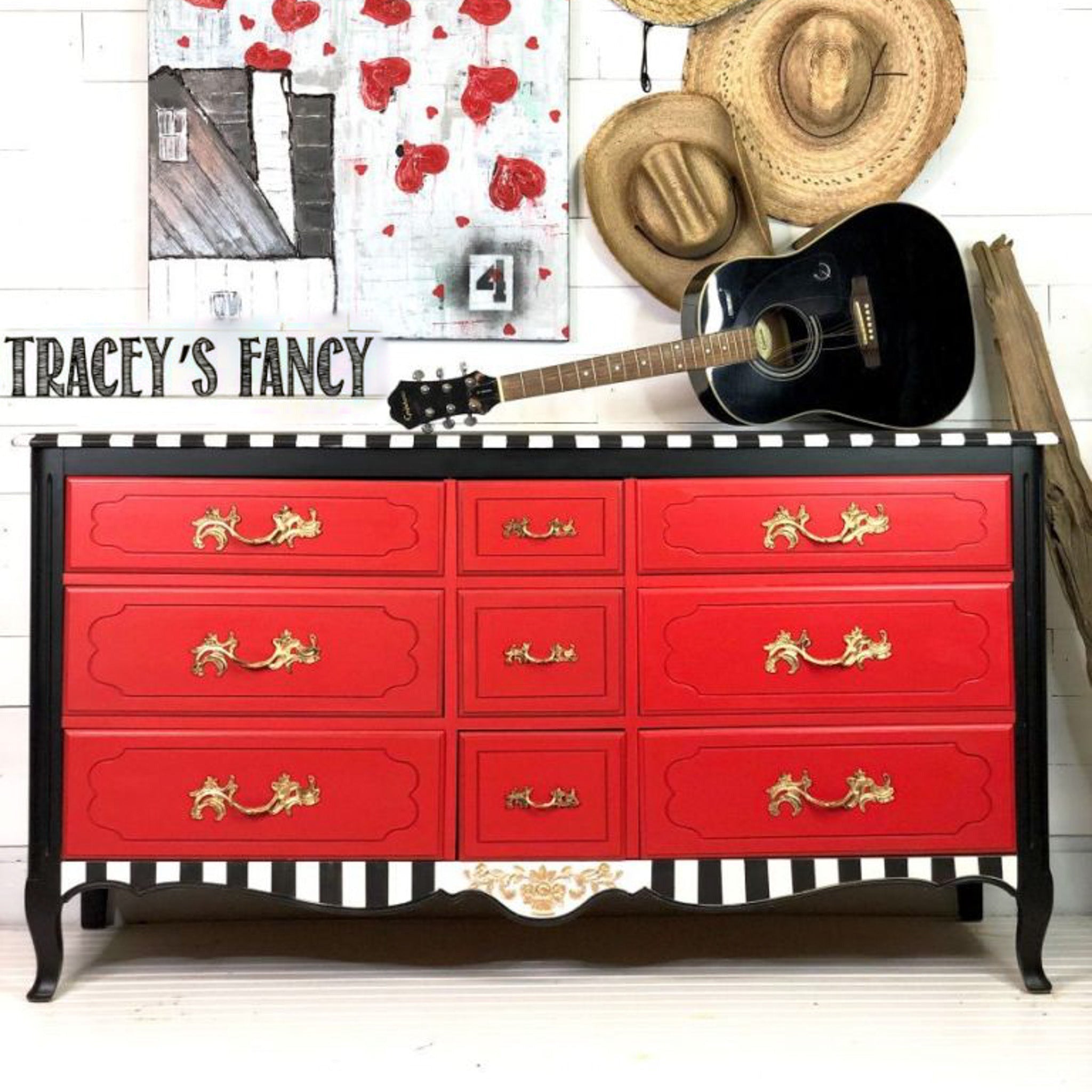 A vintage large 9-drawer dresser refurbished by Tracey's Fancy is painted black with black and white stripes and features Dixie Belle's Honky Tonk Red chalk mineral paint on its drawers.