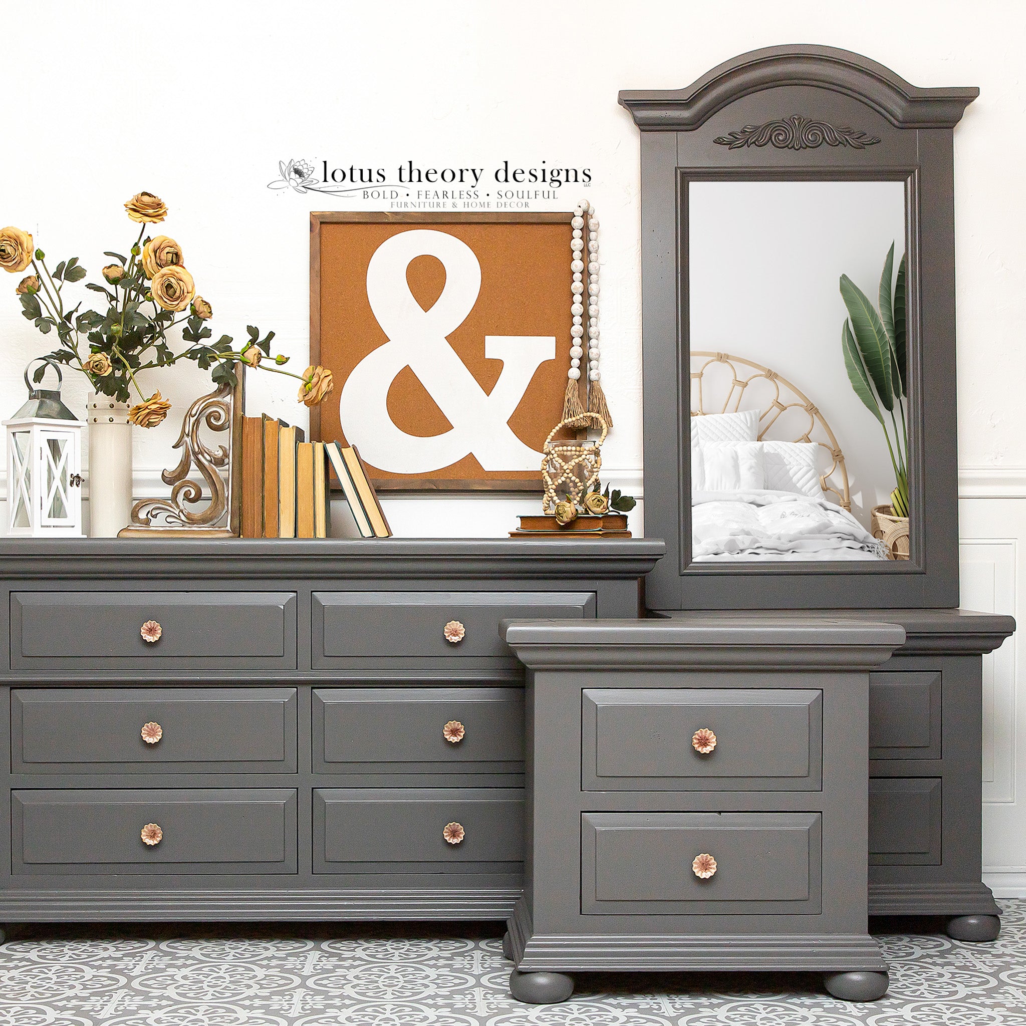 A bedroom furniture set that includes 2 nightstands, a dresser, and a mirror that have been refurbished by Lotus Theory Designs are painted in Dixie Belle's Hurricane Gray chalk mineral paint.