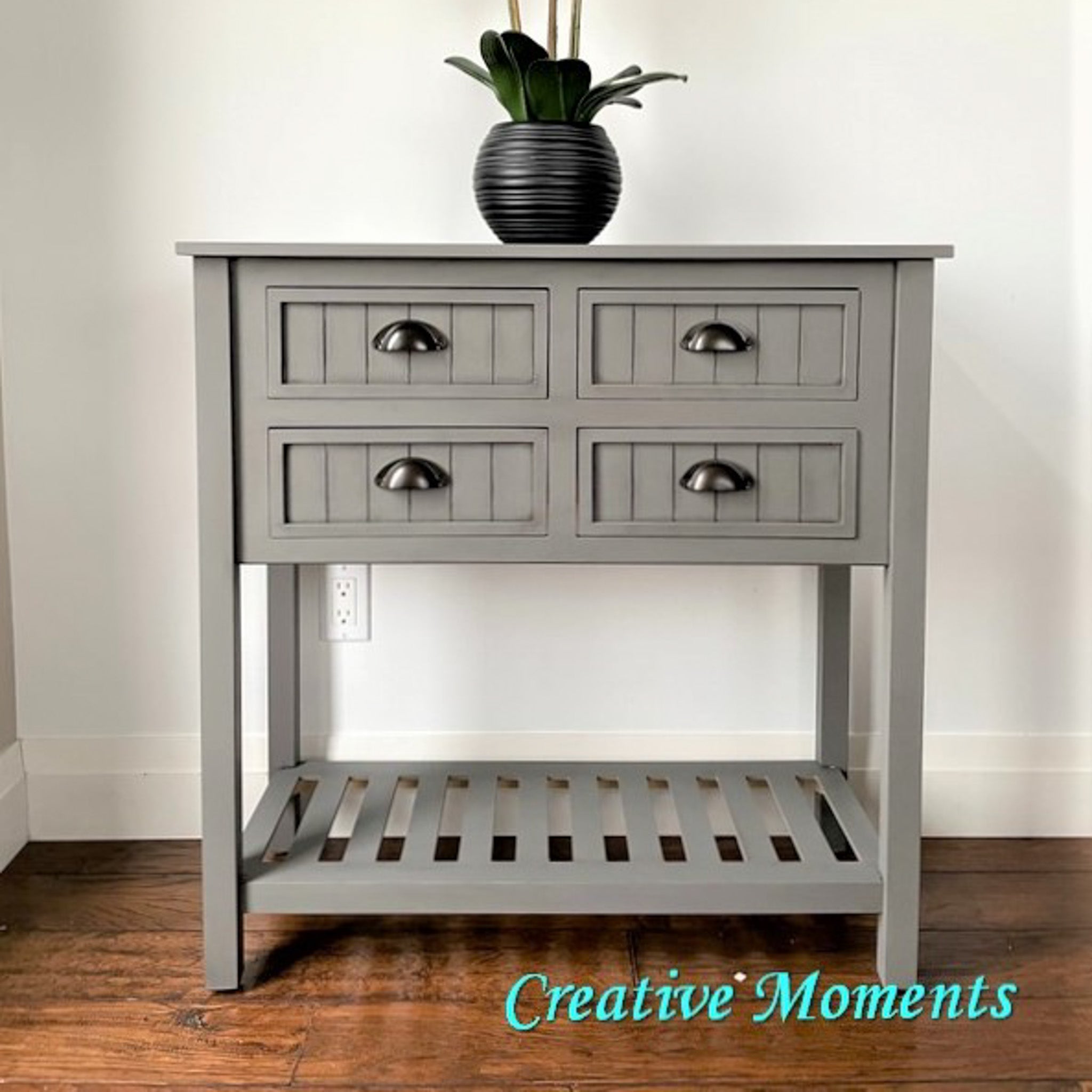 A vintage side table refurbished by Creative Moments is painted in Dixie Belle's Hurricane Gray chalk mineral paint.