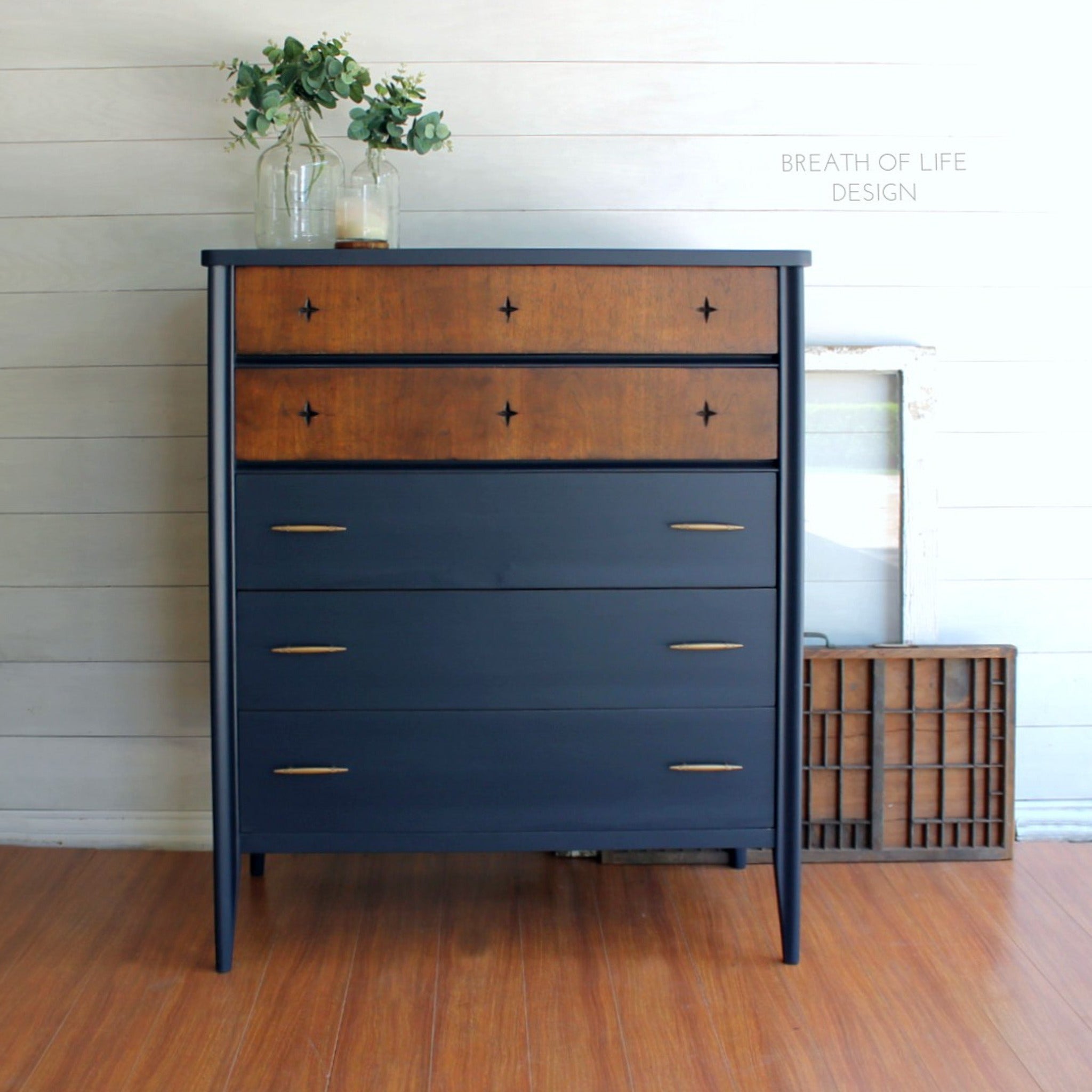 A 5-drawer chest dresser refurbished by Breath of Life Design is painted in Dixie Belle's In the Navy chalk mineral paint and the top 2 drawers are stained a natural wood color.