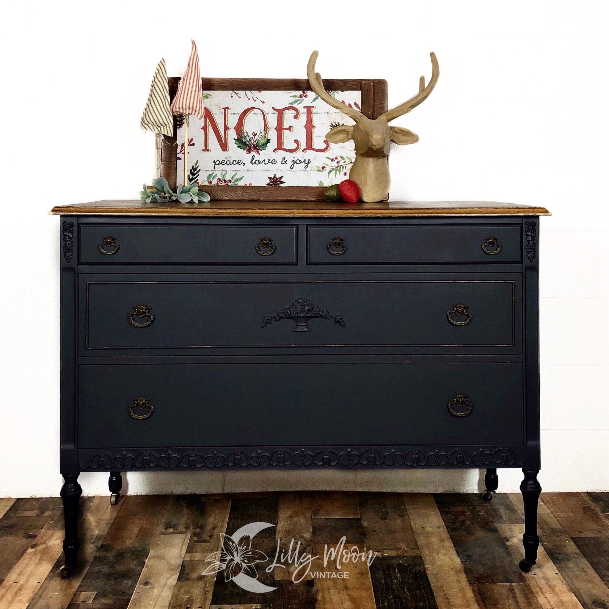 A vintage 4-drawer dresser refurbished by Lilly Moon Vintage is painted in Dixie Belle's Midnight Sky chalk mineral paint and has a natural wood top.