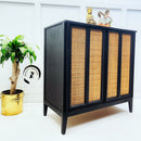 A vintage console table refurbished by With Love Furniture is painted in Dixie Belle's Midnight Sky chalk mineral paint and has cane rattan door inlays.