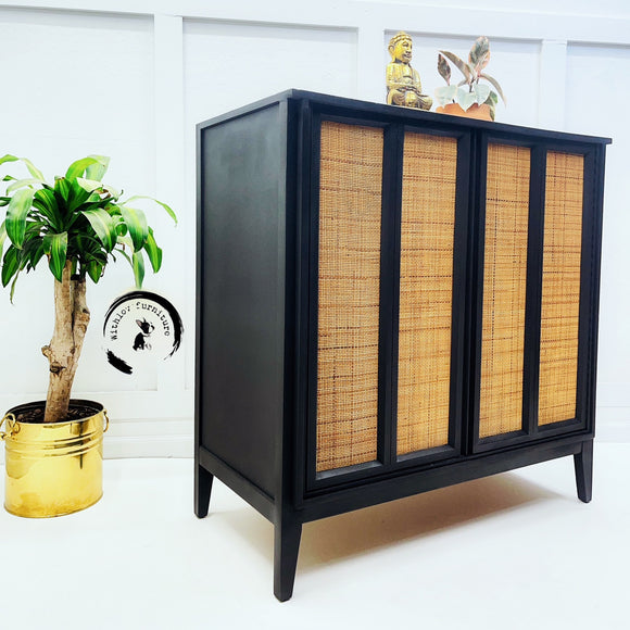 A vintage console table refurbished by With Love Furniture is painted in Dixie Belle's Midnight Sky chalk mineral paint and has cane rattan door inlays.